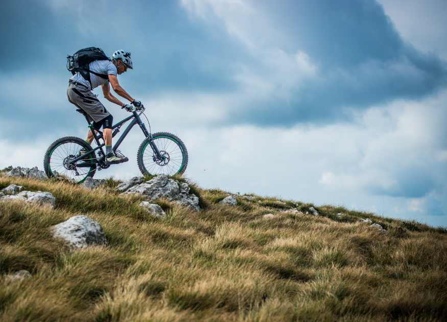Graphic of man on a mountain bike representing cyclists being welcome at The Holt holiday cottage