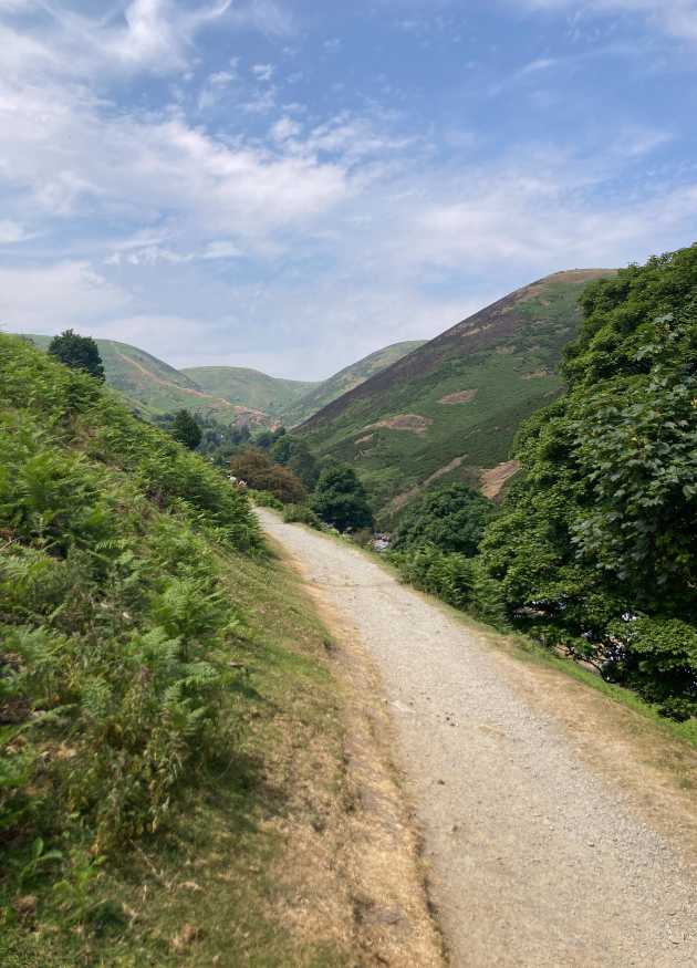 Image showing a footpath which curves down to the valley, brook and National Trust cafe at Cardingmill. This is the right hand fork just metres from The Holt holiday cottage